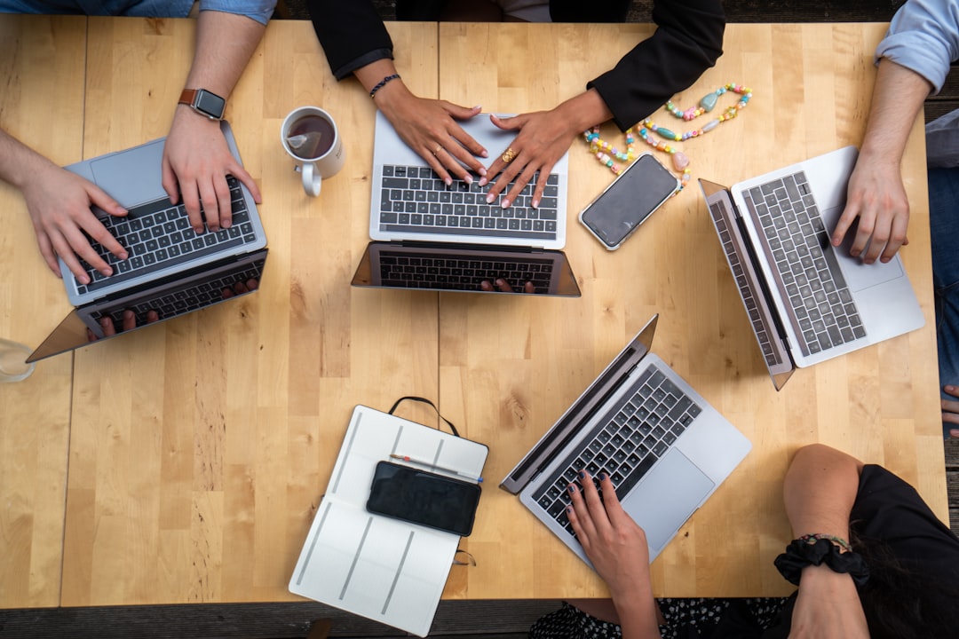 person-using-macbook-pro-on-brown-wooden-table-5ehn4wbfvbc